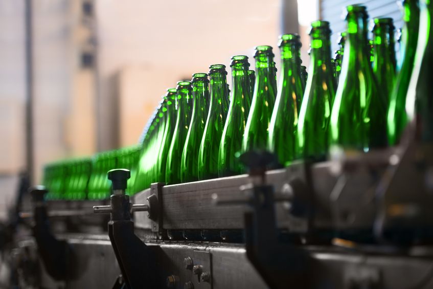 many bottles on conveyor belt in factory
